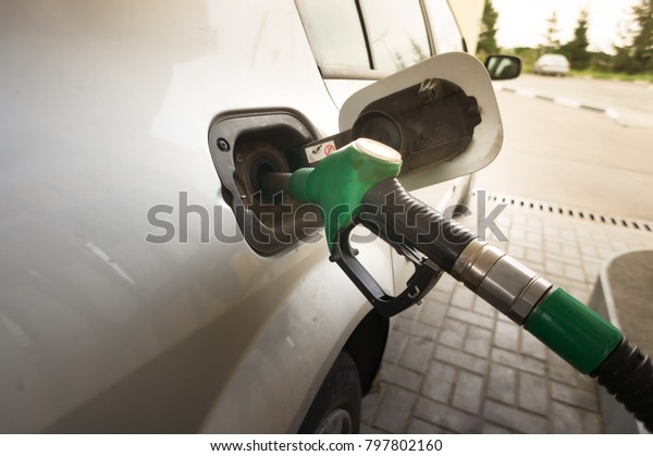To fill the machine with fuel. fill with\
gasoline at a gas station. Gas station\
pump