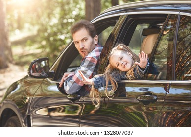 Fill Your Life With Adventures, Not Things. Father And Daughter Looking Out The Car Window And Smiling Happily At The Camera. Family Road Trip