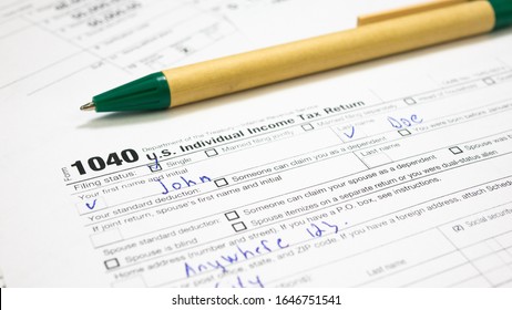 Filled 1040 Tax Form for male multiple-use names John Doe in USA. Wage and tax statement, federal income, medicare tax withheld, social security. Filing Individual income tax return in 2020  - Shutterstock ID 1646751541