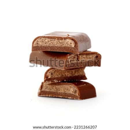 Filled Chocolate bar. Broken pieces over white background.