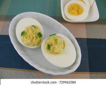 Filled eggs with pieces of cucumber