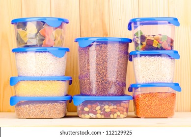 Filled Plastic Containers On Wooden Background