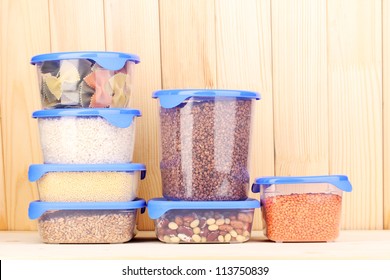 Filled Plastic Containers On Wooden Background