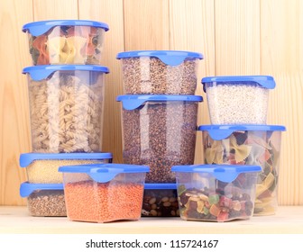 Filled Plastic Containers On Wooden Background