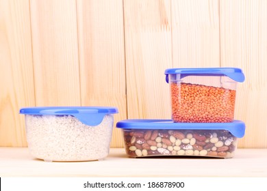 Filled Plastic Containers On Wooden Background