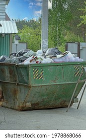 A Filled Solid Waste Container On A Village Street Close-up