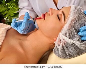 Filler injection for female forehead face. Plastic aesthetic facial surgery in beauty clinic Silicone lips in girl Doctor with syringe injects lips augmentation Spring discounts for visiting spa salon