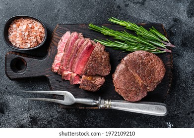 Fillet Mignon Tenderloin Grilled And Sliced Meat Beef Steaks. Black Background. Top View