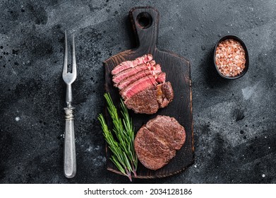 Fillet Mignon Tenderloin Grilled And Sliced Meat Beef Steaks. Black Background. Top View