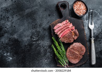 Fillet Mignon Tenderloin Grilled And Sliced Meat Beef Steaks. Black Background. Top View. Copy Space