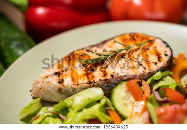 Fillet of salmon with\
cooked vegetables.