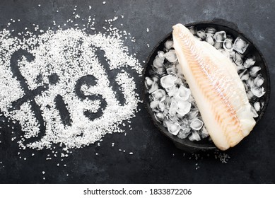 Fillet Of White Sea Cold-water Fish Cod In Ice Cubes On A Dark Background. Top View.