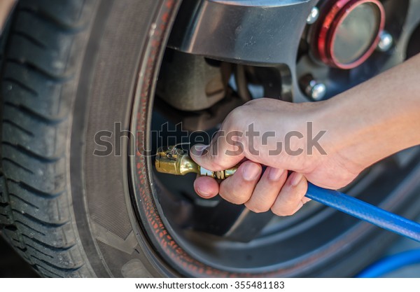 pumping air into car tires