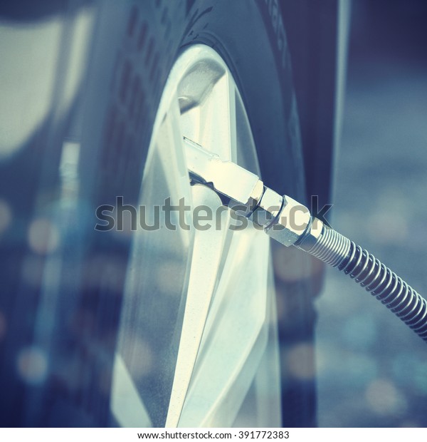 Filling air into a car\
tire