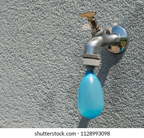 Filling Blue Water Ballon On Faucet With Water