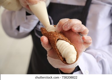 Filling a cannoli pastry cream with ricotta Italian dessert pastry