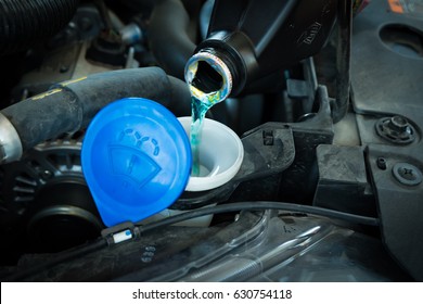 Filling Car Reservoir With Windshield Wiper Fluid Before Travel.