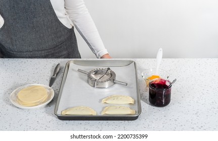 Filling Empanada Dough With Blueberry Pie Filling To Make Sweet Empanadas With Blueberries.