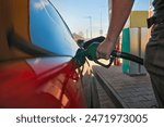 Filling fuel into a car at a petrol station pump