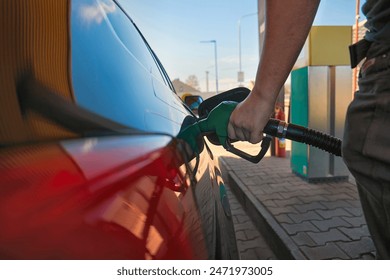 Filling fuel into a car at a petrol station pump