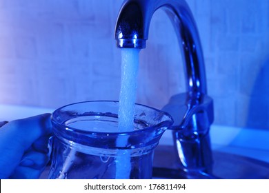 Filling Up Glass Pitcher Of Water