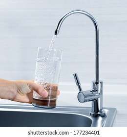 Filling Glass Of Water In Hand From Kitchen Faucet