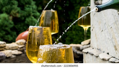 Filling Glasses With White Wine In The Fountain