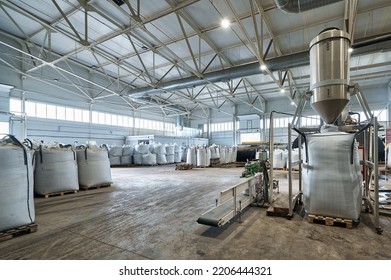 Filling huge bags with reprocessed products in warehouse - Shutterstock ID 2206444321