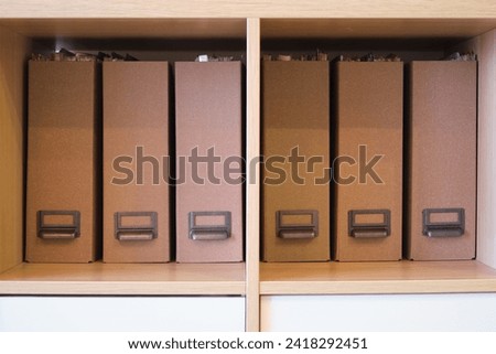 Filling the office cabinet with folders with documents, arranging files