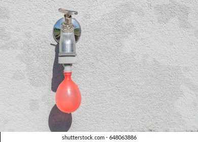 Filling On Faucet A Red Water Ballon For Play