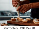 filling pastery with cream. chef prepare finger food. 
