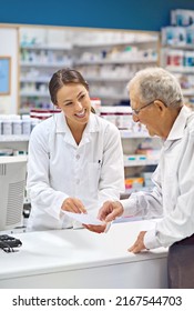 Filling prescriptions with a smile. Shot of a young pharmacist helping an elderly customer at the prescription counter.