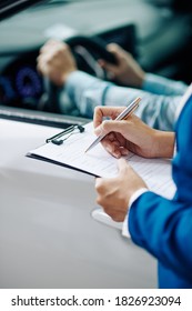 Filling questionnaire for customer before test drive in car dealership