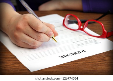 filling resume on wooden table, close-up - Shutterstock ID 126974384