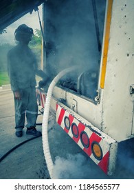 Filling Tanker Truck With Liquid Nitrogen. Cold Metal Pipe Smoking From Transferring Liquid Nitrogen