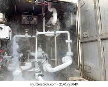 Filling Tanker Truck With Liquid Nitrogen. Cold Metal Pipe Smoking From Transferring Liquid Nitrogen.