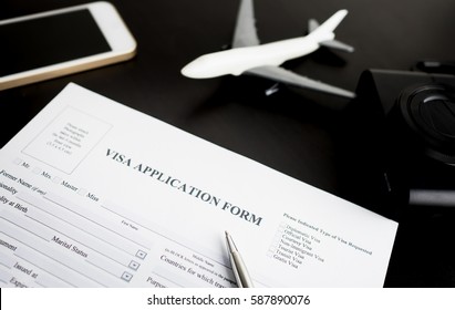 Filling Travel Visa Application Immigration 
Form For Vacation And Business Travel. With Blank VISA Application Form Ready To Fill In For Immigrant Arrival.