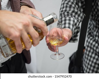 Filling A Whisky Glass From A Bottle At A Whisky Tasting Event