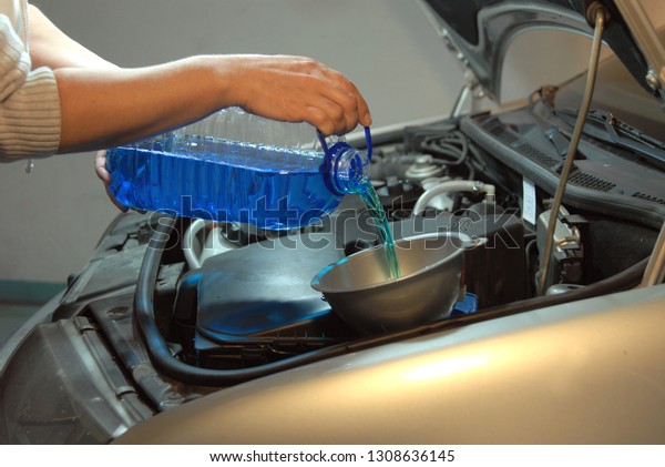 Filling the
windshield washer fluid on a Car
