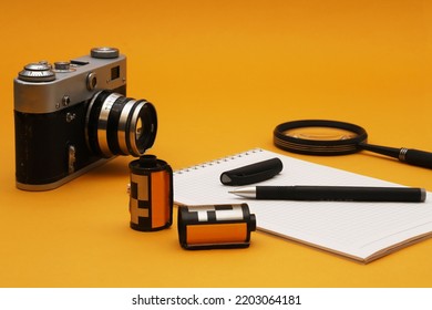 A Film Camera On A Photojournalist's Desk. Shallow Depth Of Field