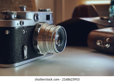 Film camera unknown model. Manual object. In the background is a leather case of cabura. - Powered by Shutterstock