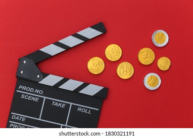 Film Clapper Board With Coins On Red Background. Cinema Industry, Entertainment. Top View