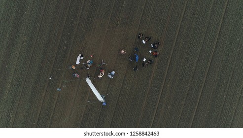 Film Crew Setting Up Scene In Crop Field Winter 
