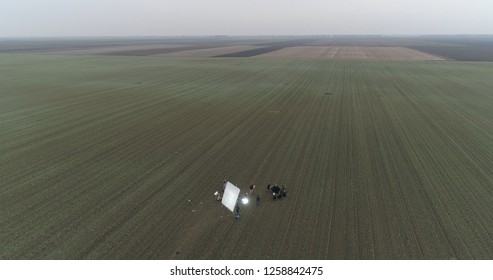 Film Crew Setting Up Scene In Crop Field Winter 05