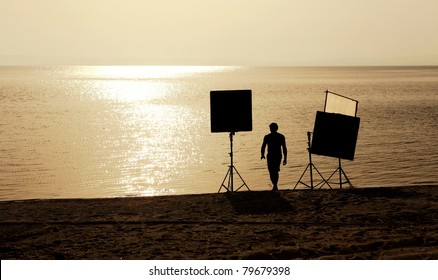 Film Crew Setting Up Scene On A Beach