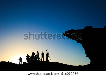 film crew silhouette at sunset in mountains