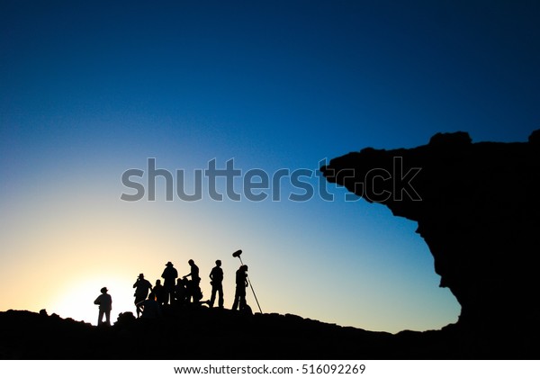 film crew\
silhouette at sunset in\
mountains