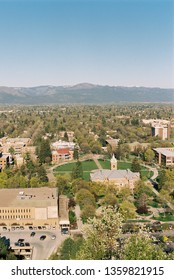 A Film Image And Aerial View Of The University Of Montana Campus With The Oval And Main Hall In The Center Taken From Mount Sentinel Trail In Missoula, Montana With Mountains In The Distance.