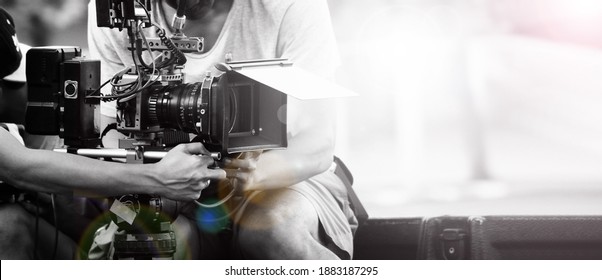 Film Industry. Filming With Professional Camera. Videographer Holding 4k Cam On Dslr Rig Or Gimbal Stabilizer Set. Pro Equipment Helps To Make Videos Without Shaking. Video Production.