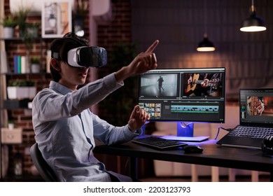 Film maker editing movie montage with virtual reality glasses, using multimedia production software to create footage. Edit video with color grading and visual effects, working with vr goggles. - Shutterstock ID 2203123793